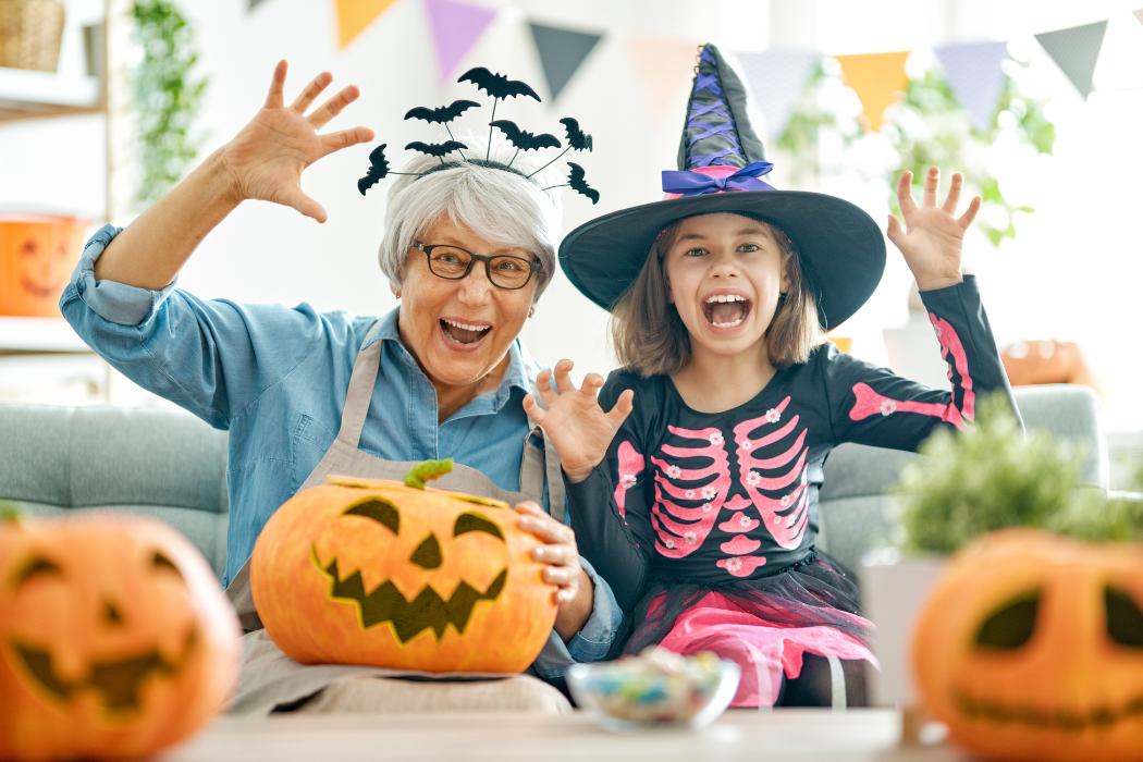 A girl and a senior women celebrating Halloween.